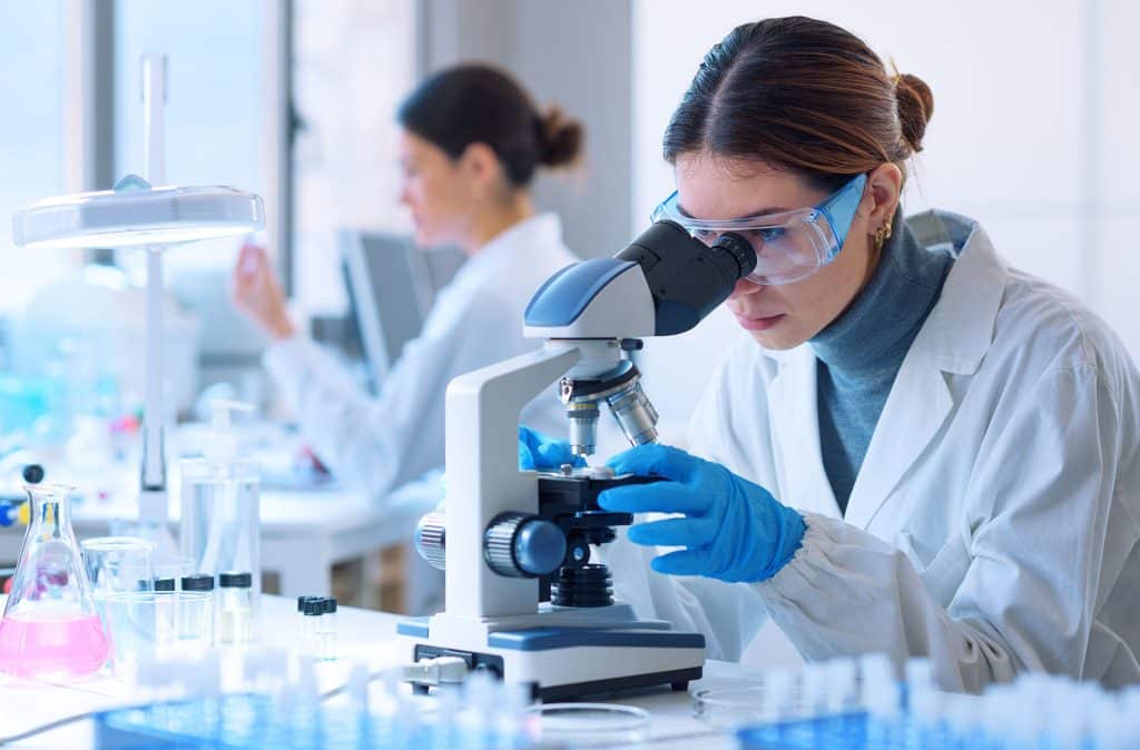 Women working in a lab with microscope